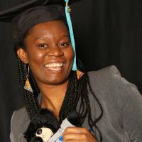 masters student poses with stuffed bear